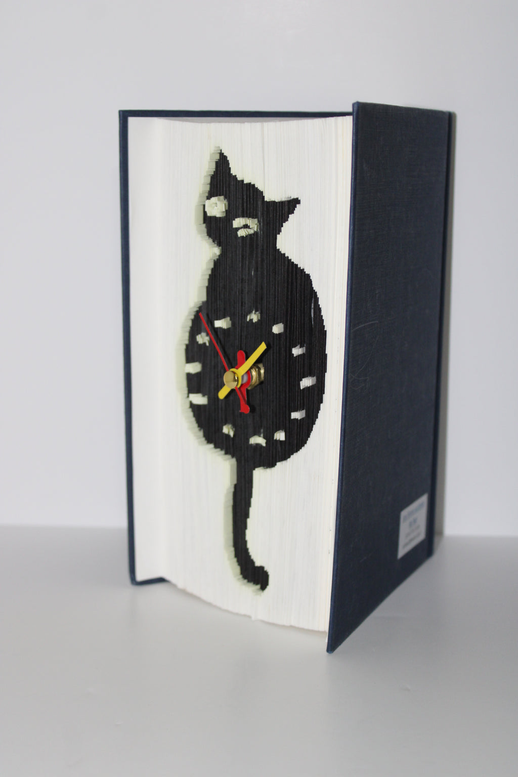 Livre pendule chat noir